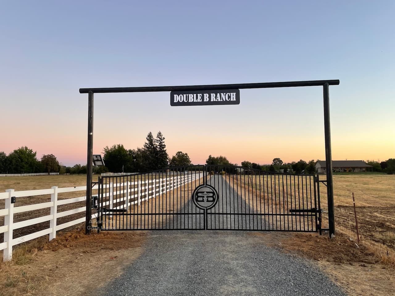 Custom ranch entrance gate with overhead sign and branding installed by Automatic Gate Mates in Bay Area