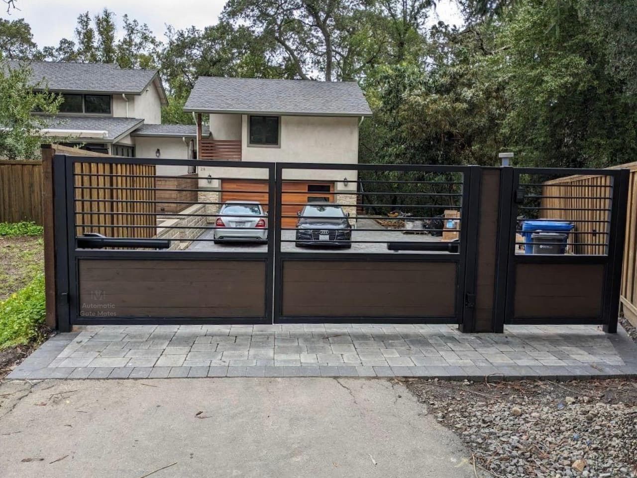 Modern horizontal slat gate with metal and wood panels installed by Automatic Gate Mates in Bay Area residential driveway