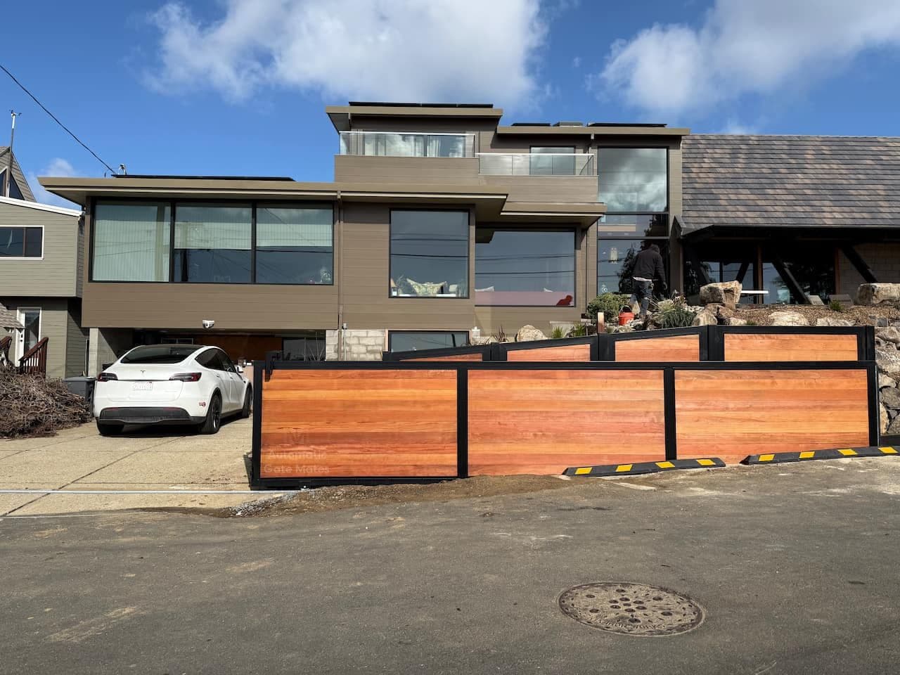 Modern horizontal wood sliding gate installation for contemporary home in Bay Area by Automatic Gate Mates